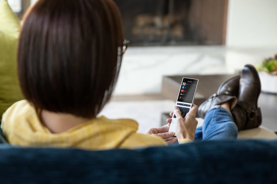 Family relaxing with the Control4 remote